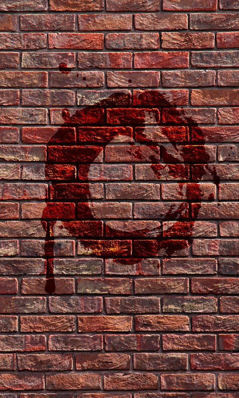 Blutiges O an einer Backsteinmauer